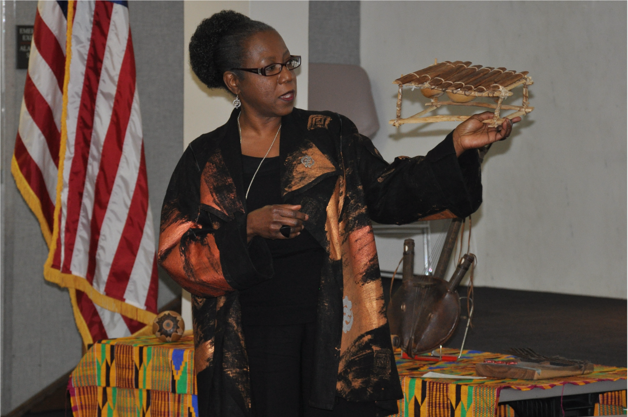Freddi Williams Evans holding a xylophone during a lecture